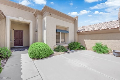 Doorway to property with stucco siding, a patio ar