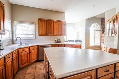 Kitchen featuring brown cabinetry, a sink, stainle