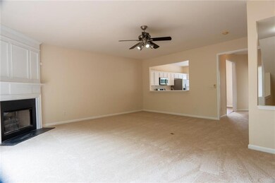 Unfurnished living room featuring light colored ca