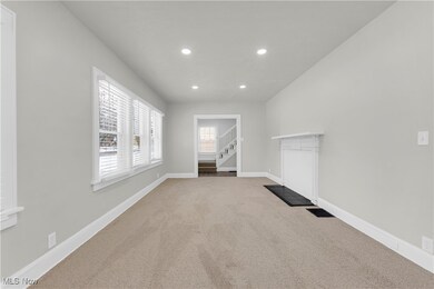 Unfurnished living room featuring carpet floors