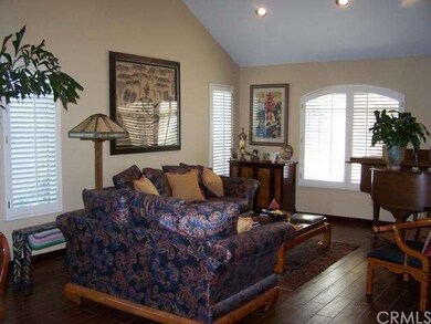 Formal living room with recessed lighting, plantat
