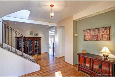 The spacious and formal entry features hard wood f