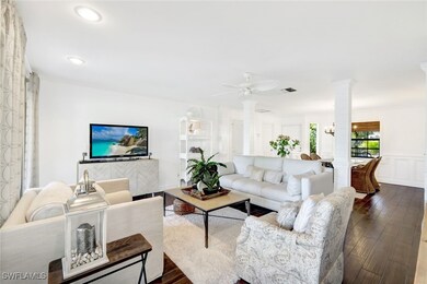 Living room featuring ceiling fan with notable cha