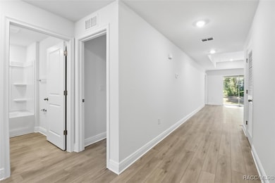 Foyer with the guest bathroom and bedroom to the left upon entering the home