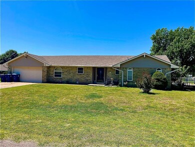 Single story home featuring a garage and a front l