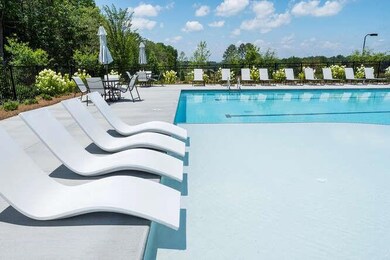 Community pool with a patio and fence