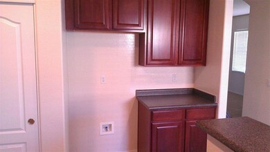 refrigerator space with cabinets