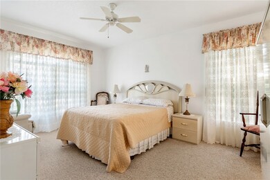 Primary bedroom has two large windows offering ple