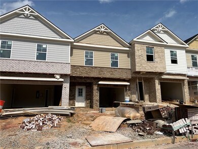 Townhome / multi-family property with brick siding and an attached garage
