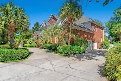 View of front of house with driveway, brick siding, and a garage