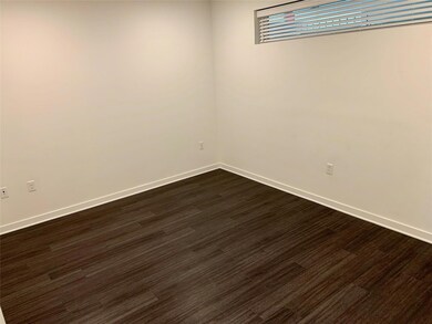 Spare room featuring dark wood finished floors