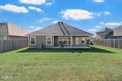 Rear view of property with a patio, a fenced backyard, and a shingled roof