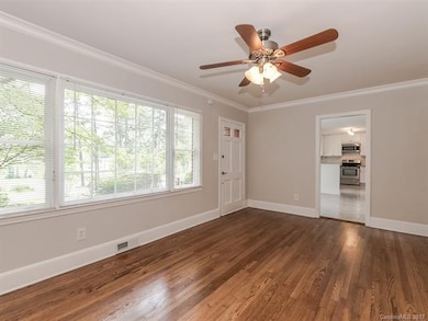 Light and airy Living Room has refinished hardwood
