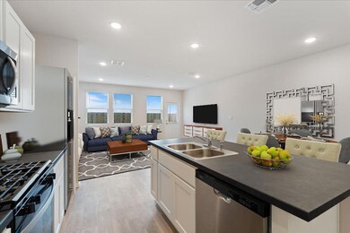 Kitchen with stainless steel appliances, open flo