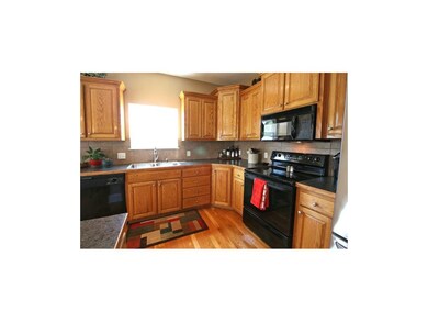 Kitchen Work Area: Oak Cabinets, Stainless Double 