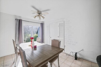 Dining area featuring light tile patterned floors and a ceiling fan