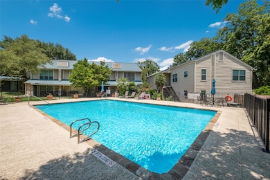 Community pool featuring stairs and a patio