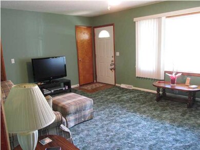 Living room has a big picture window to let in lot