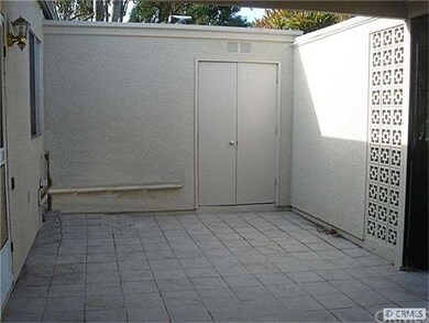 Washer/dryer behind double doors in patio