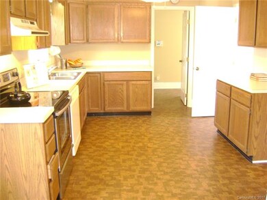 Spacious kitchen features plenty of cupboards. Low