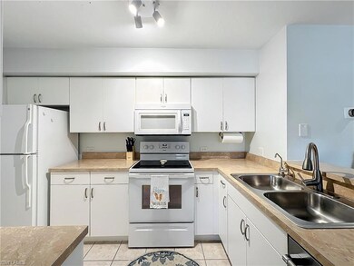 Kitchen with light tile patterned flooring, sink, 