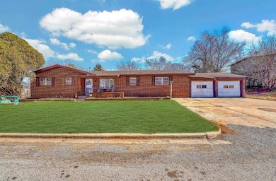 Ranch-style house featuring driveway, an attached 