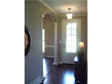 Warm Welcoming Entry with hardwood flooring and 8 