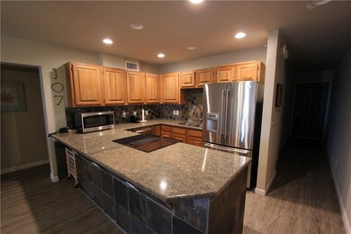 Beautiful kitchen area with granite counters and S