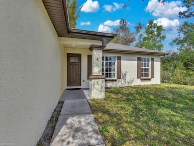 Entrance to property featuring stucco siding and a