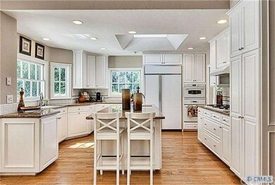Kitchen. (Note the hardwood floors, granite counte