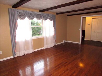 Living Room. A Beamed Ceiling adds to the Beauty o