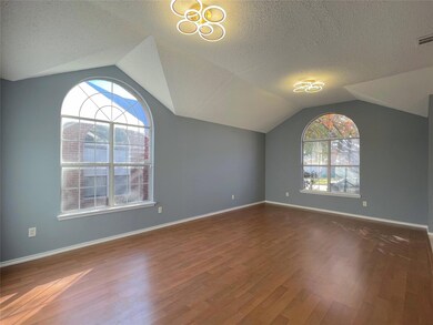 Additional living space with a textured ceiling, l