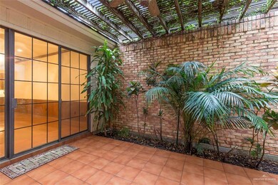 Texas tropical paradise atrium with saltillo tile is flanked by foyer, second bedroom, study, living room, and family room.  Large enough for an Outdoor Kitchen and Dining area.