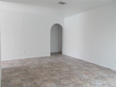 Unfurnished room featuring arched walkways