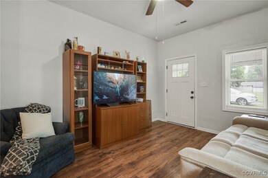 Living room with dark wood finished floors and cei