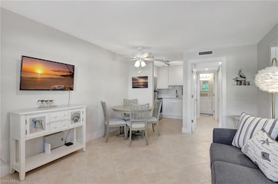 Dining area with ceiling fan, light tile patterned
