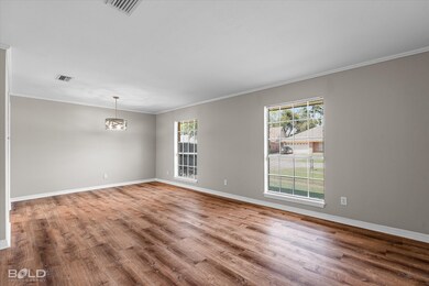 Unfurnished room with ornamental molding and wood finished floors