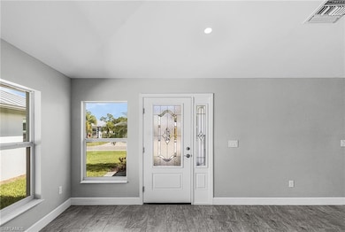 Entrance foyer featuring baseboards and recessed lighting