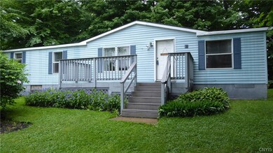 Front view with deck and beautiful flowers