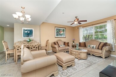 Living area with light tile patterned floors, a chandelier, baseboards, a ceiling fan, and recessed lighting