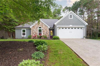 Ranch-style home featuring an attached garage, sto