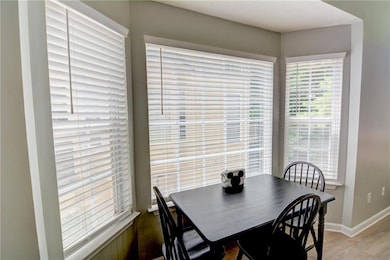 Dining area featuring light wood-style flooring and baseboards