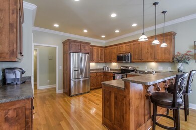 Kitchen has lots of counter and cabinet space and a breakfast bar.