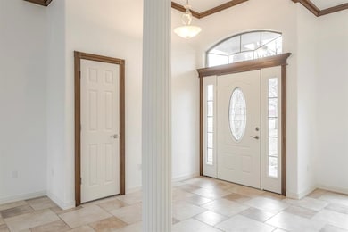 Entrance foyer featuring ornamental molding