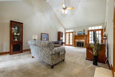 To the left of the foyer is the cozy living room with vaulted ceilings and fireplace with lots of natural light.