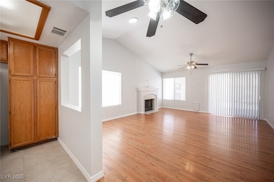 Unfurnished living room with ceiling fan, lofted c