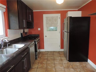 Kitchen leads to enclosed rear sun porch.