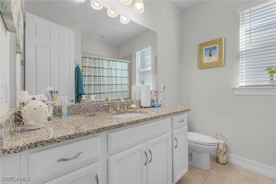 Bathroom featuring walk in shower, vanity, tile pa