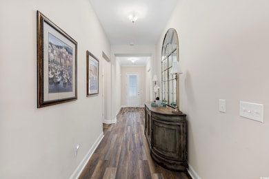 Hallway with baseboards and dark wood finished flo