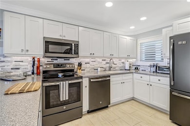 Tile floors, white cabinets, newer appliances.